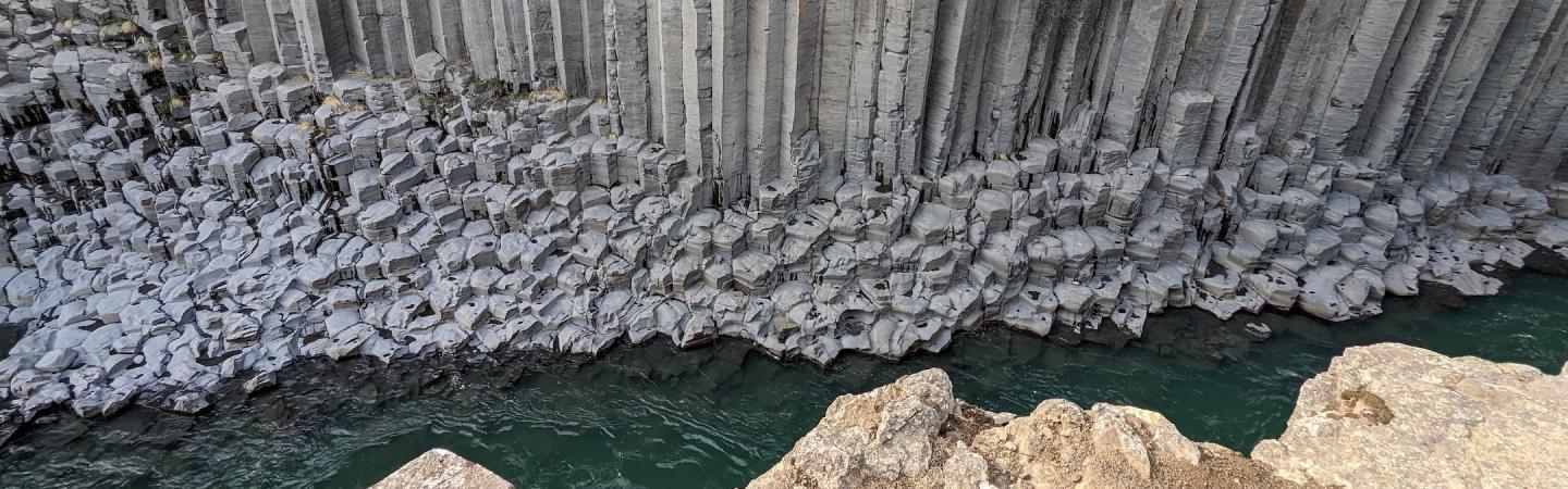 basalt rock formation over river