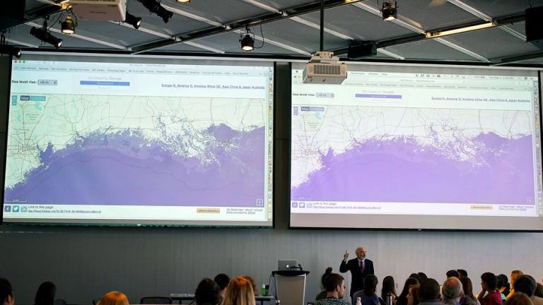 Professor John Sterman displays maps showing the consequences of sea-level rise on various coastal cities, as part of the “SimPlanet” event at MIT.