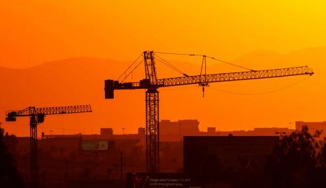 Construction cranes in Phoenix on July 13, 2023, the 14th day in a row of temperatures 110 degrees or more.