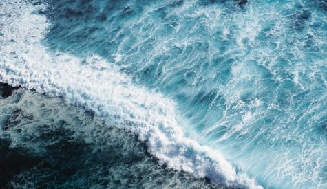 Aerial photograph of an ocean wave crashing