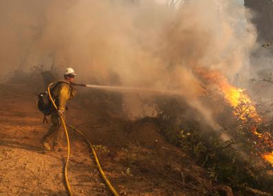 firefighter battling a wildfire